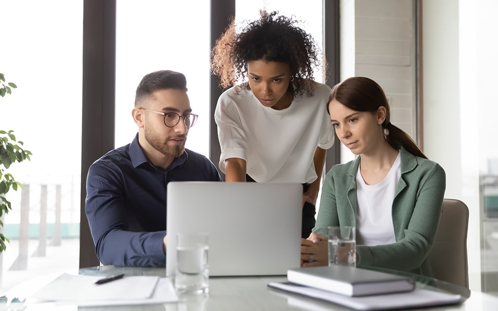 concentrated-multiracial-businesspeople-gather-in-boardroom- assess-min